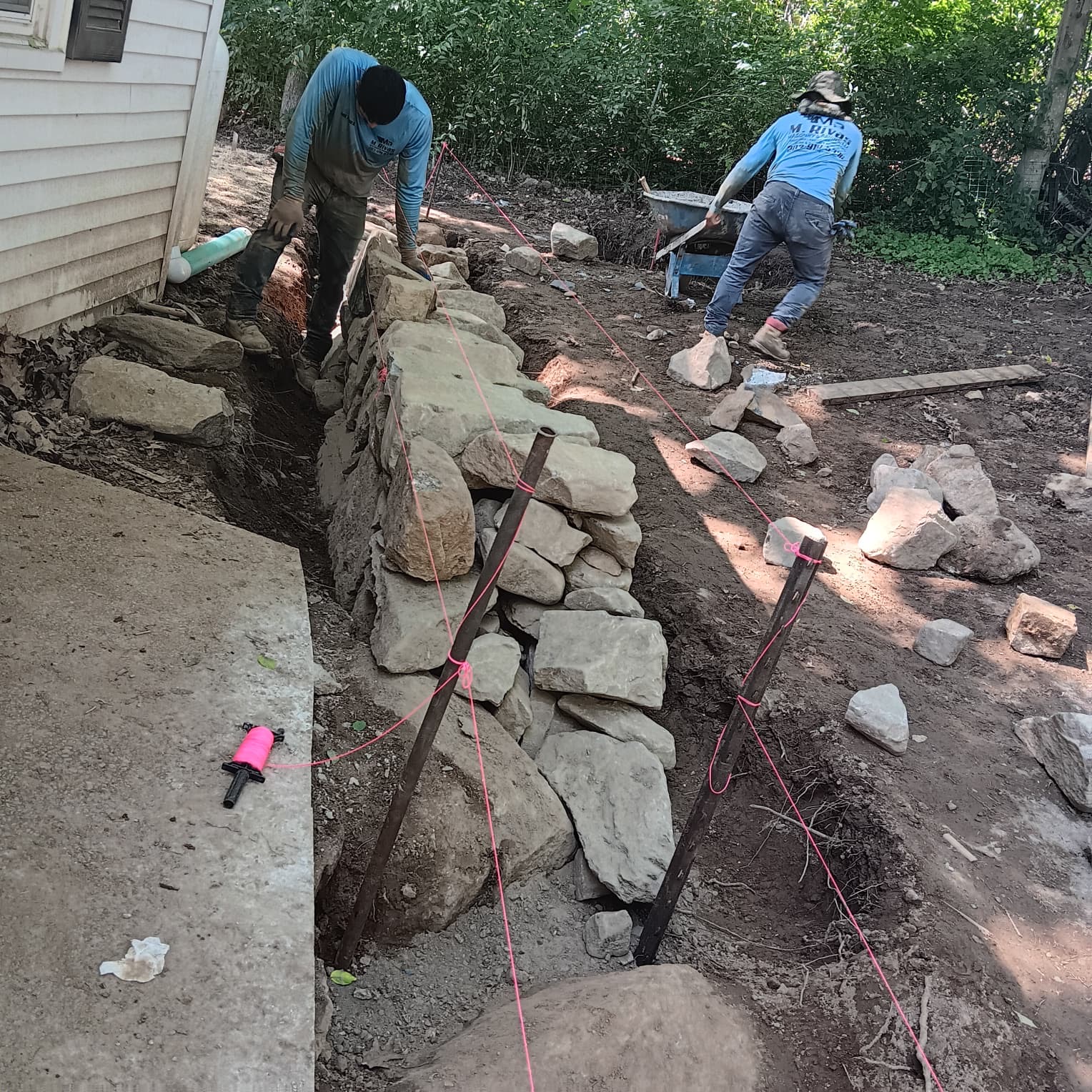 Stone retaining wall construction in progress
