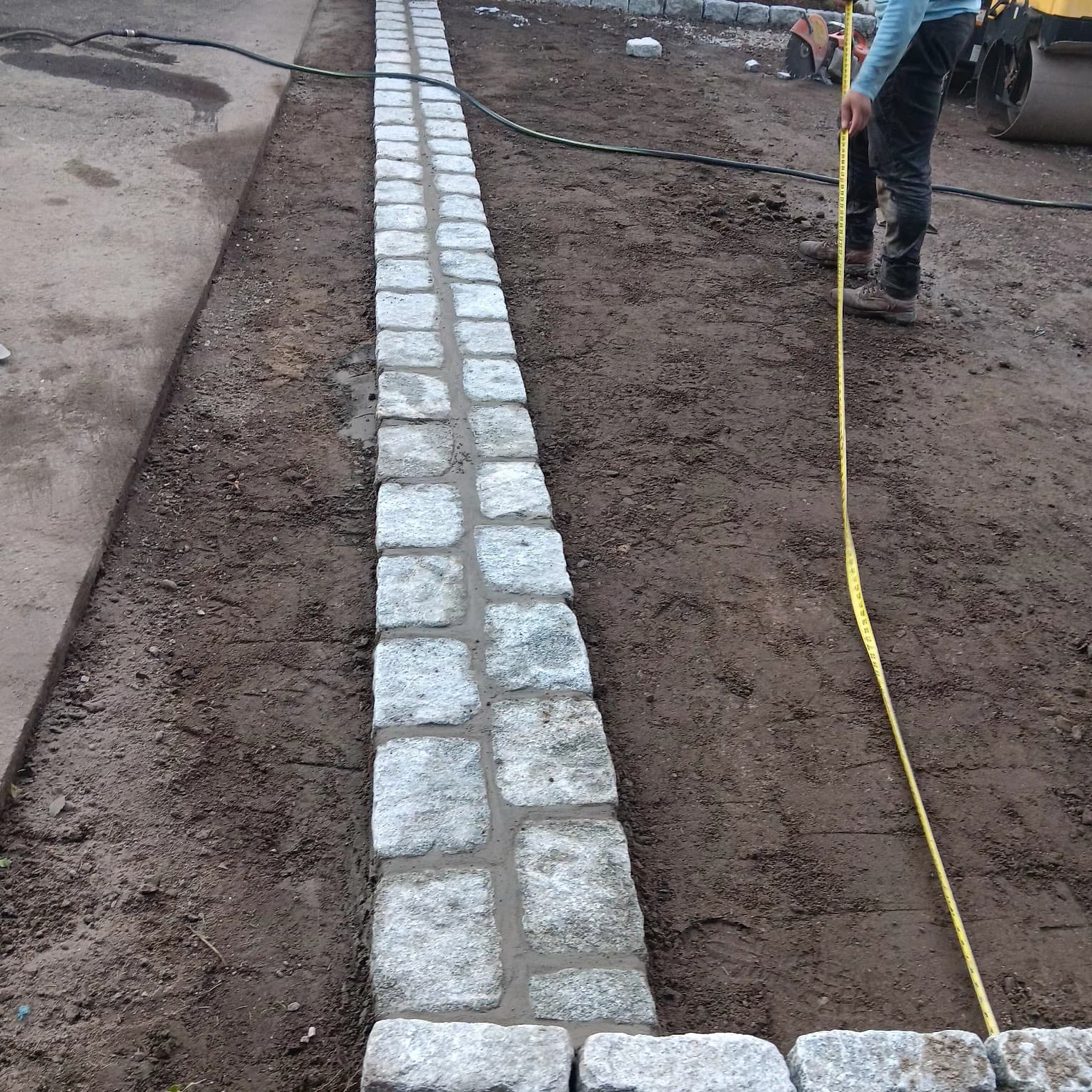 Granite cobblestone curbing along driveway edge